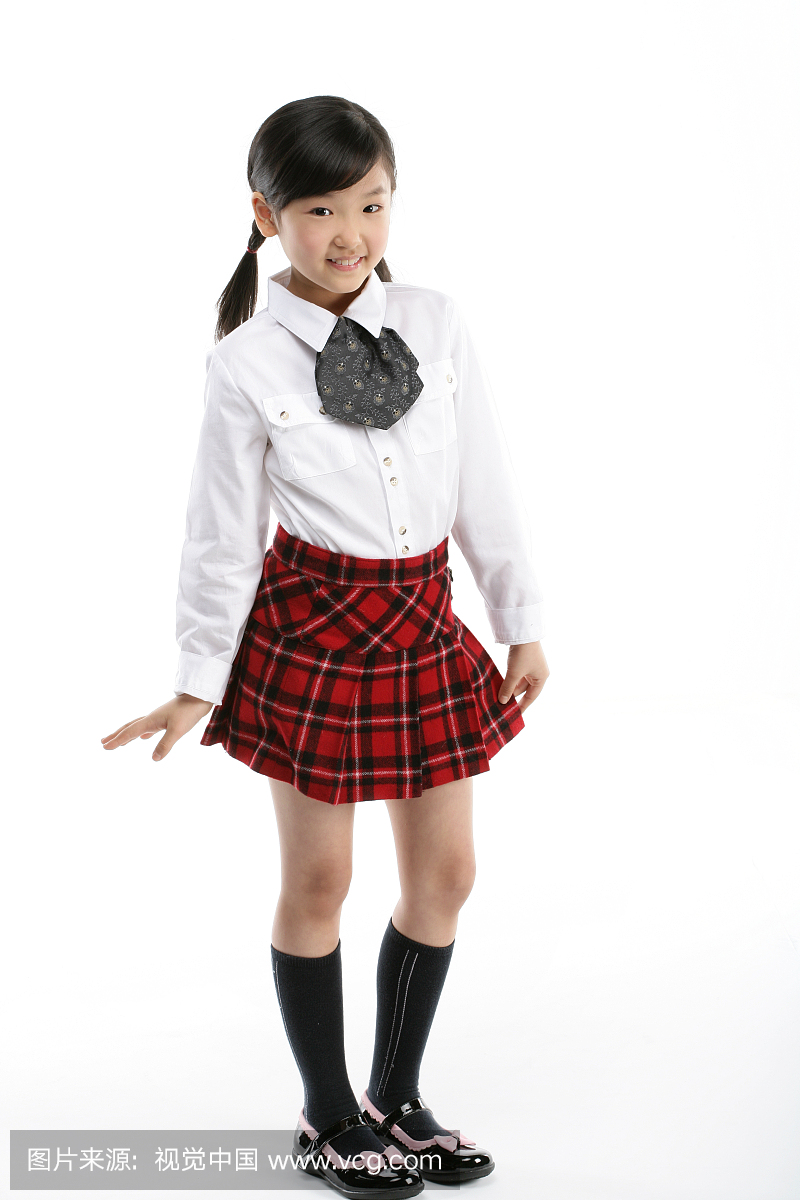 Girl (12-13) wearing button down shirt and skirt