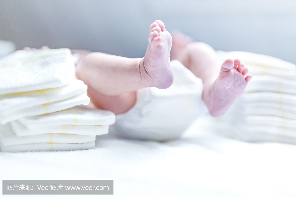新生婴儿的脚在换尿布的桌子上