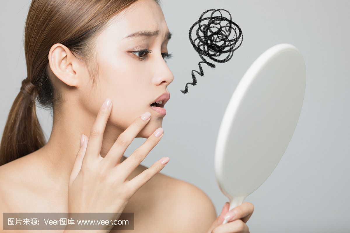 Young woman checking her skin. Skin care con