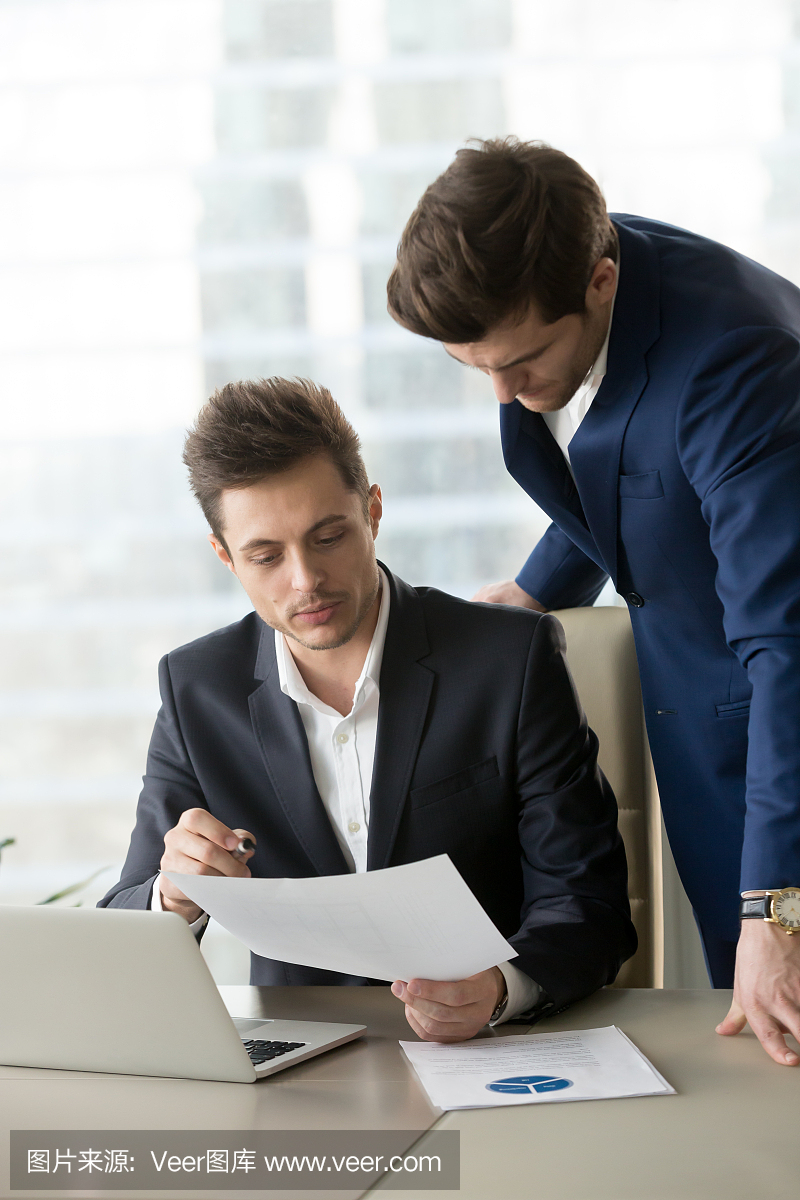 Employee explaining details in document to bo