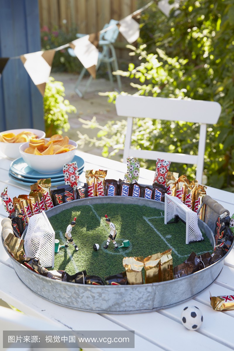 Stylised football pitch on metal tray with artificia