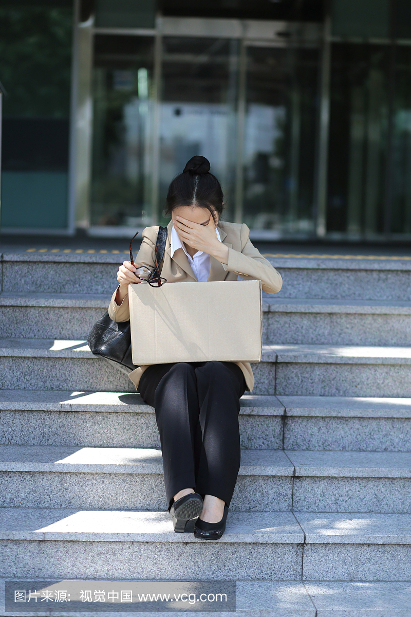 Disappointed Businesswoman Sitting on Outdo