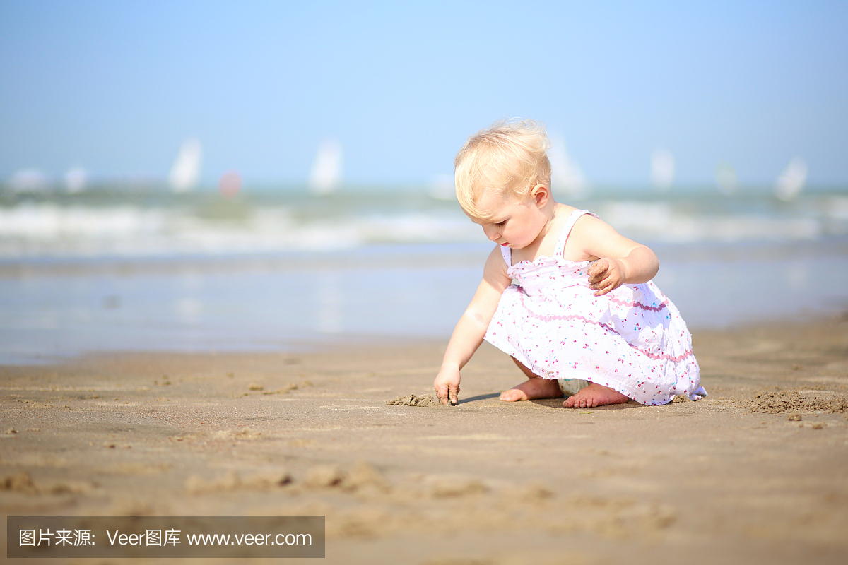 漂亮的衣服画在海滩上的女婴