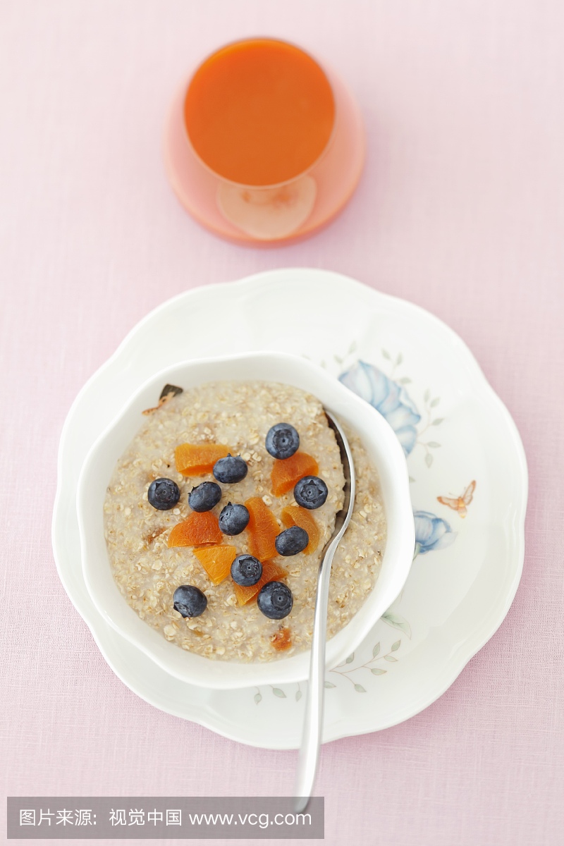 Porridge with dried apricots, blueberries and ca