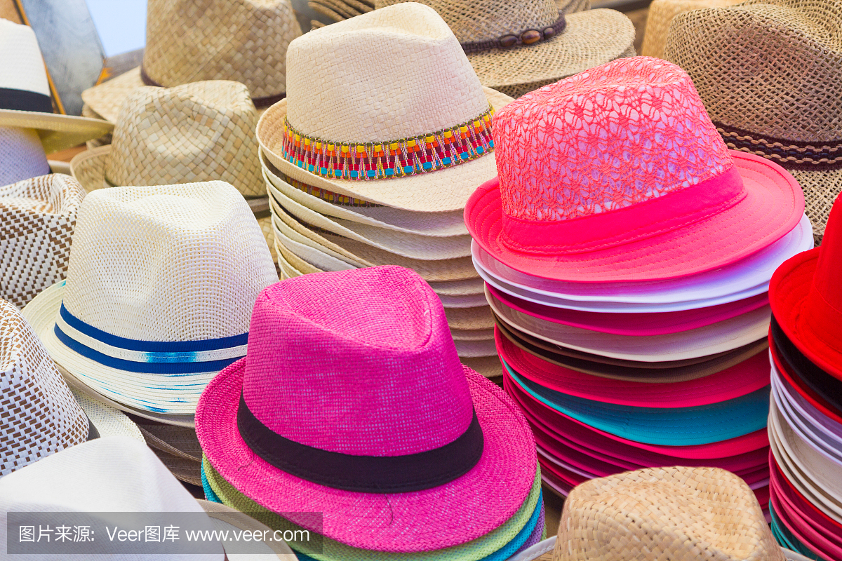 夏天所有颜色的许多帽子