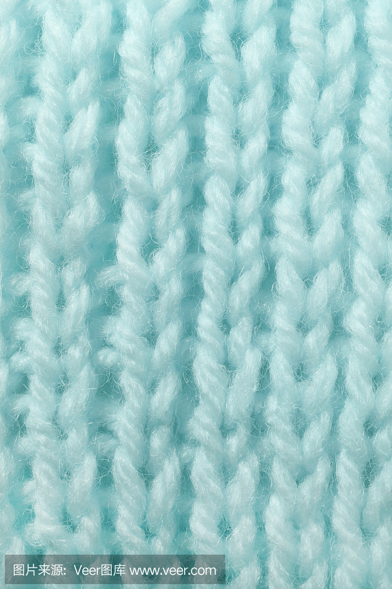 天蓝色羊毛编织纹理。垂直横跨编织钩针详细的