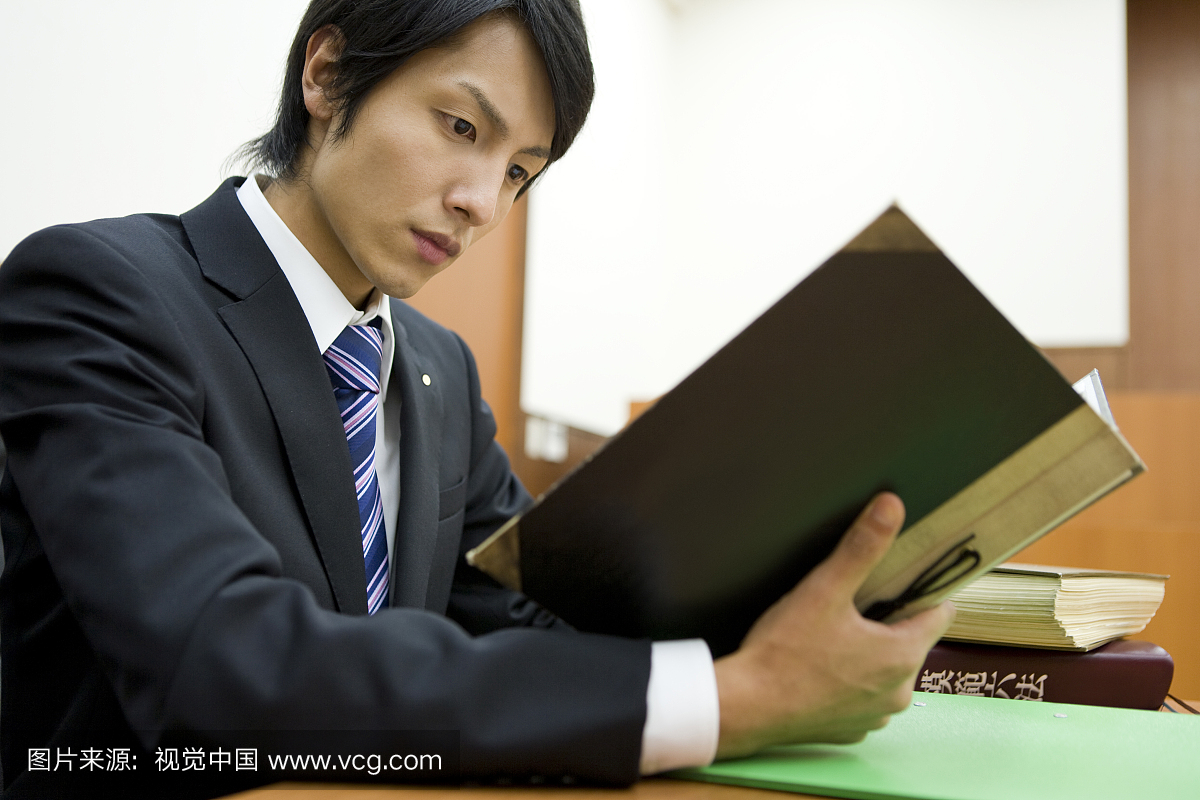 Lawyer Reviewing Case Documents In Court