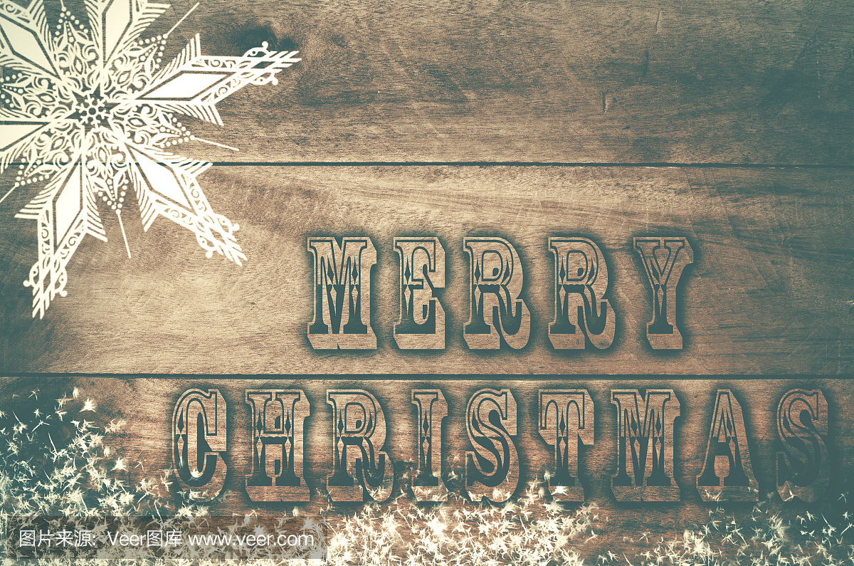 单词圣诞快乐写的,在木雪地背景上被烧的字母