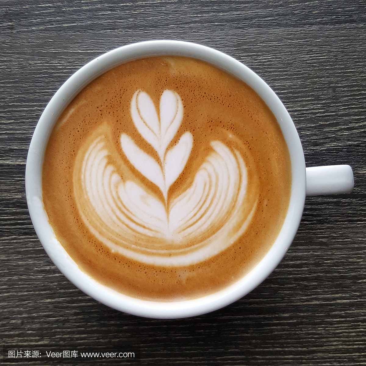 Top view of a mug of latte art coffee.