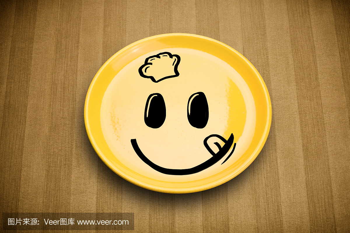 快乐的笑脸卡通脸上多彩的盘子上