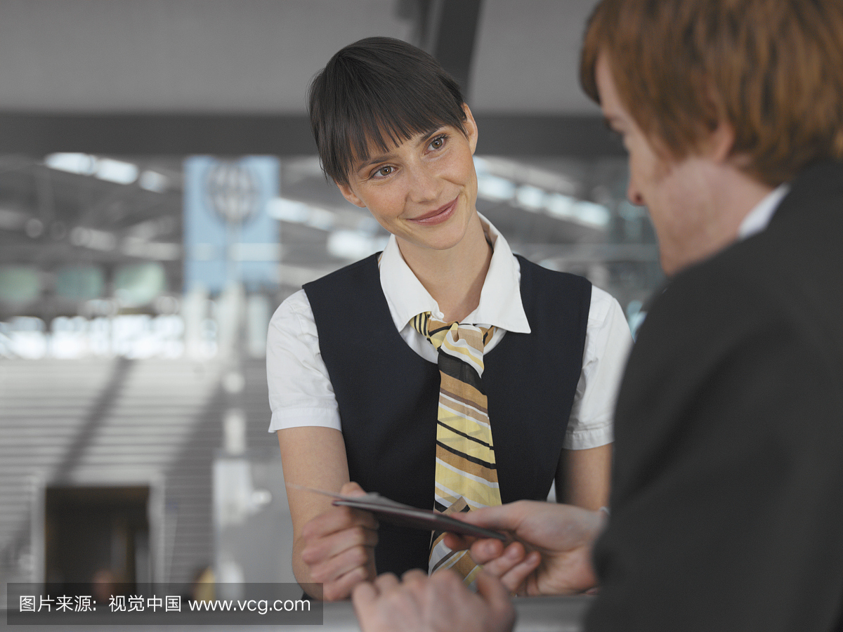 mployee assisting a customer at the check-in c