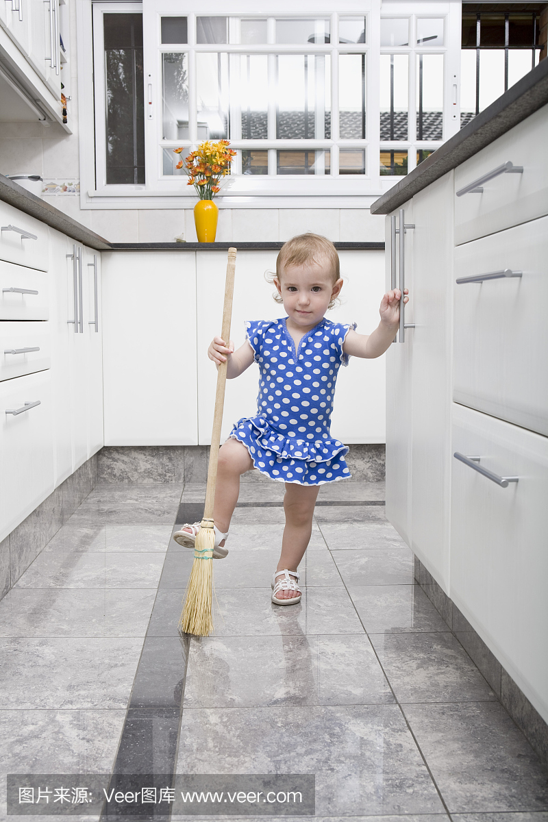 清洁厨房地板的女婴