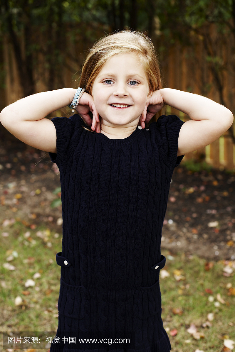 Young Smiling Girl With Hands on Shoulders